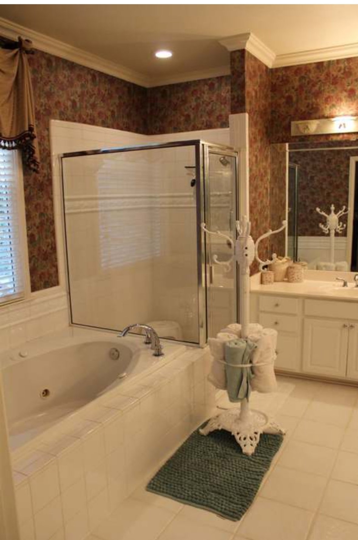 Bathroom with jetted tub and glass shower before renovation