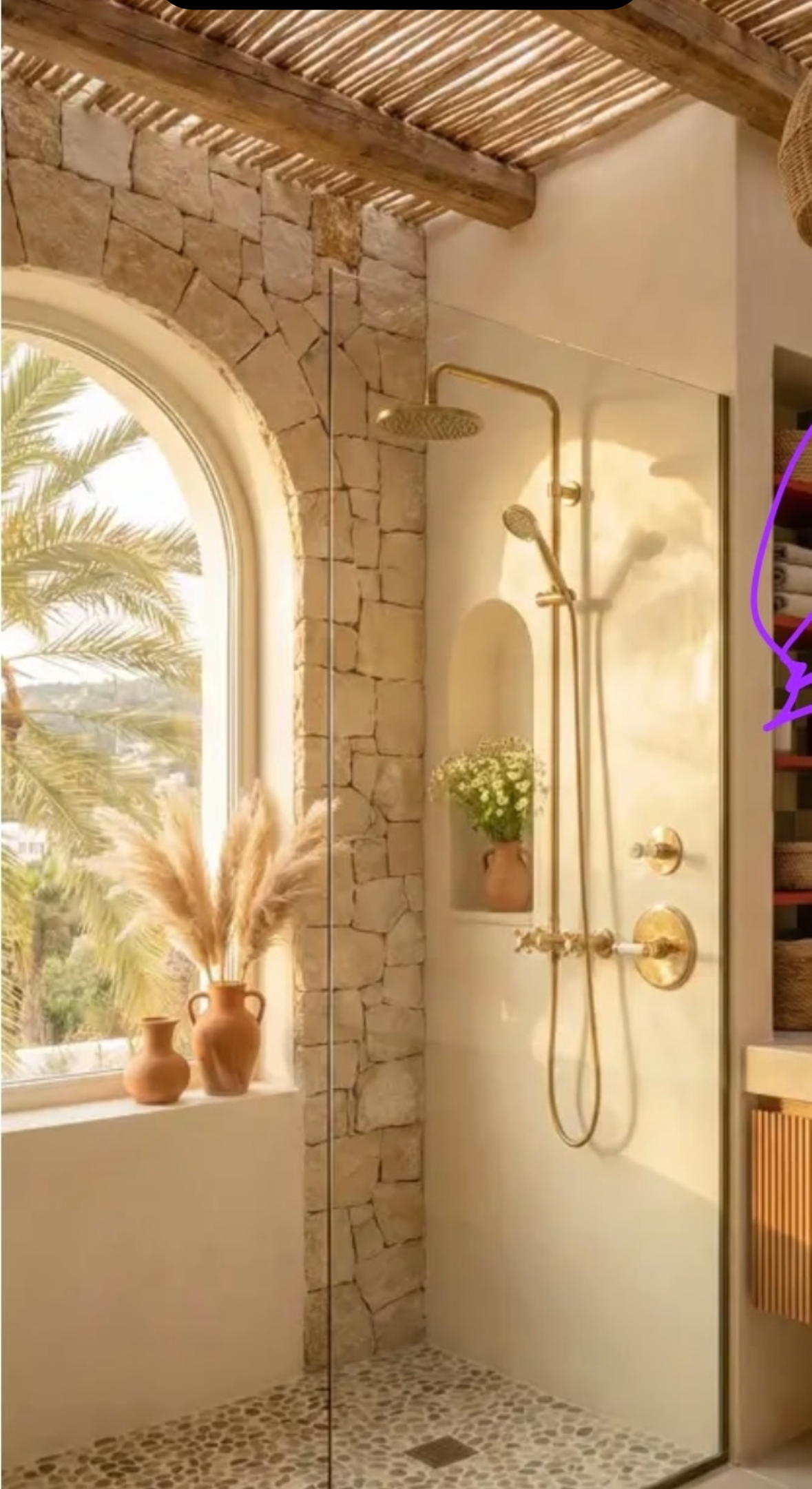 Completed luxury walk-in shower with stone walls and gold fixtures